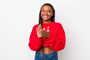 afro pretty woman feeling happy and successful, smiling and clapping hands, saying congratulations with an applause