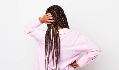 afro pretty woman thinking or doubting, scratching head, feeling puzzled and confused, back or rear view