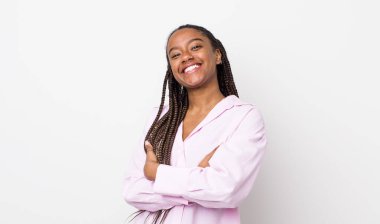 afro pretty woman laughing happily with arms crossed, with a relaxed, positive and satisfied pose