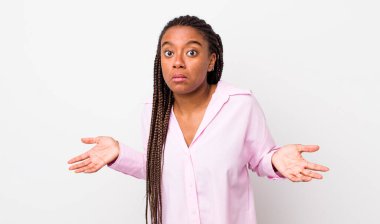 afro pretty woman feeling clueless and confused, having no idea, absolutely puzzled with a dumb or foolish look