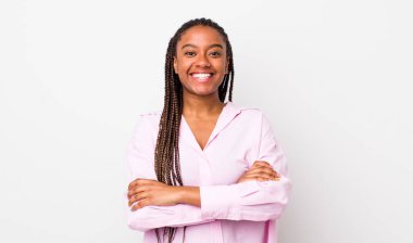 afro pretty woman looking like a happy, proud and satisfied achiever smiling with arms crossed