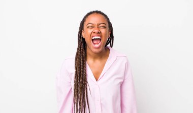 afro pretty woman shouting aggressively, looking very angry, frustrated, outraged or annoyed, screaming no