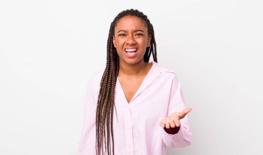 afro pretty woman looking angry, annoyed and frustrated screaming wtf or whats wrong with you 