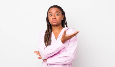 afro pretty woman feeling confused and clueless, wondering about a doubtful explanation or thought