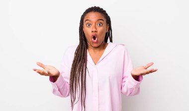 afro pretty woman open-mouthed and amazed, shocked and astonished with an unbelievable surprise