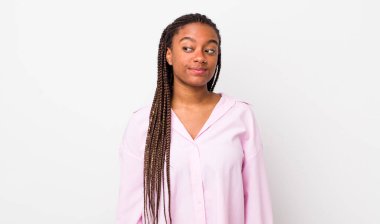 afro pretty woman wondering, thinking happy thoughts and ideas, daydreaming, looking to copy space on side