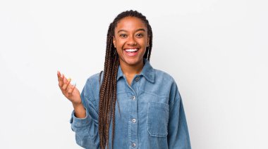afro pretty woman feeling happy, surprised and cheerful, smiling with positive attitude, realizing a solution or idea