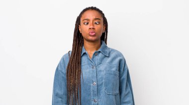 afro pretty woman looking goofy and funny with a silly cross-eyed expression, joking and fooling around