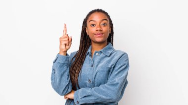 afro pretty woman feeling like a genius holding finger proudly up in the air after realizing a great idea, saying eureka