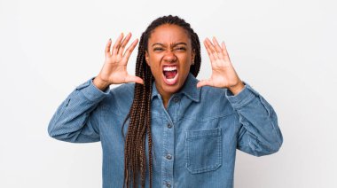 afro pretty woman screaming in panic or anger, shocked, terrified or furious, with hands next to head