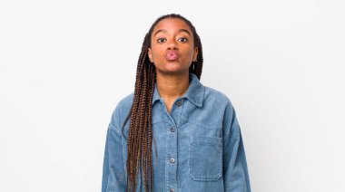 afro pretty woman pressing lips together with a cute, fun, happy, lovely expression, sending a kiss