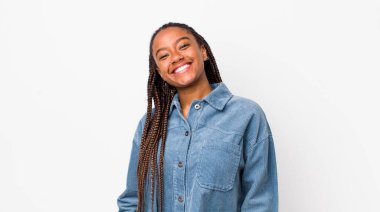 afro pretty woman smiling cheerfully and casually with a positive, happy, confident and relaxed expression
