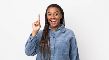 afro pretty woman feeling like a happy and excited genius after realizing an idea, cheerfully raising finger, eureka!