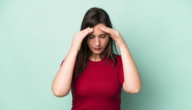 young adult pretty woman looking stressed and frustrated, working under pressure with a headache and troubled with problems