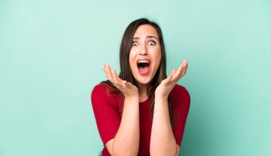 young adult pretty woman looking desperate and frustrated, stressed, unhappy and annoyed, shouting and screaming
