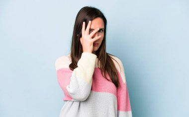 young adult pretty woman feeling bored, frustrated and sleepy after a tiresome, dull and tedious task, holding face with hand