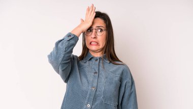 young adult pretty woman raising palm to forehead thinking oops, after making a stupid mistake or remembering, feeling dumb