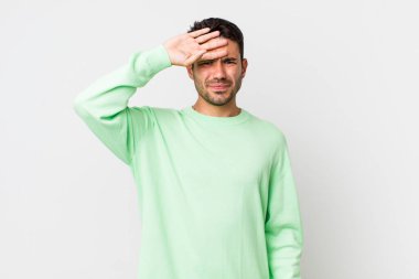 young handsome hicpanic man looking stressed, tired and frustrated, drying sweat off forehead, feeling hopeless and exhausted