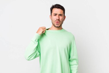 young handsome hicpanic man feeling stressed, anxious, tired and frustrated, pulling shirt neck, looking frustrated with problem