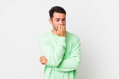 young handsome hicpanic man feeling serious, thoughtful and concerned, staring sideways with hand pressed against chin