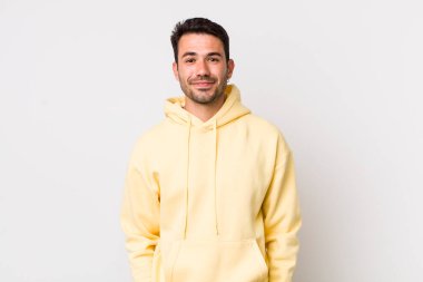 young handsome hicpanic man looking proud, confident, cool, cheeky and arrogant, smiling, feeling successful