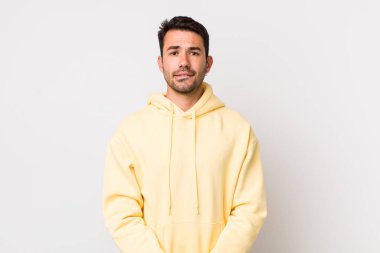 young handsome hicpanic man looking puzzled and confused, biting lip with a nervous gesture, not knowing the answer to the problem