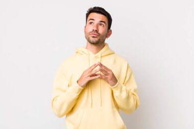 young handsome hicpanic man scheming and conspiring, thinking devious tricks and cheats, cunning and betraying