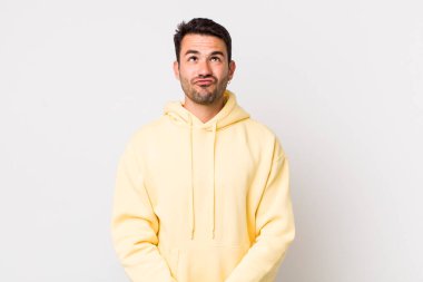 young handsome hicpanic man looking goofy and funny with a silly cross-eyed expression, joking and fooling around