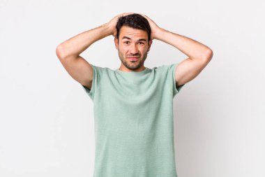 young handsome hicpanic man feeling frustrated and annoyed, sick and tired of failure, fed-up with dull, boring tasks