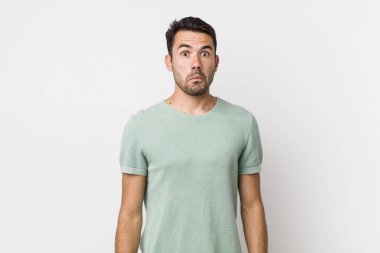 young handsome hicpanic man feeling sad and stressed, upset because of a bad surprise, with a negative, anxious look