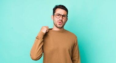 young handsome hicpanic man feeling stressed, anxious, tired and frustrated, pulling shirt neck, looking frustrated with problem