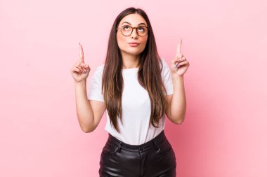 Şok olmuş, şaşırmış ve ağzı açık genç bir kadın. İki elini de havaya kaldırıp boşluğu dolduruyor.