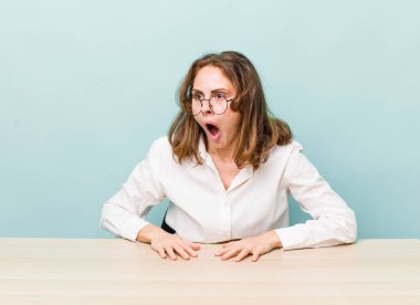 young pretty businesswoman sitting with a table