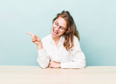 young pretty businesswoman sitting with a table