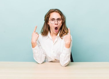 young pretty businesswoman sitting with a table