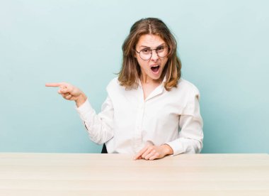 young pretty businesswoman sitting with a table