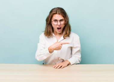 young pretty businesswoman sitting with a table