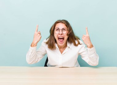 young pretty businesswoman sitting with a table