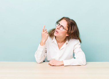 young pretty businesswoman sitting with a table