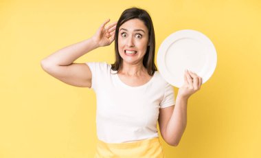young adult pretty woman home chef with empty plate