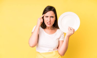 young adult pretty woman home chef with empty plate
