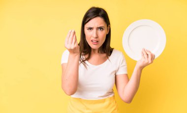 young adult pretty woman home chef with empty plate