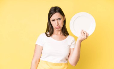 young adult pretty woman home chef with empty plate