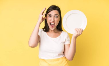 young adult pretty woman home chef with empty plate
