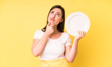 young adult pretty woman home chef with empty plate