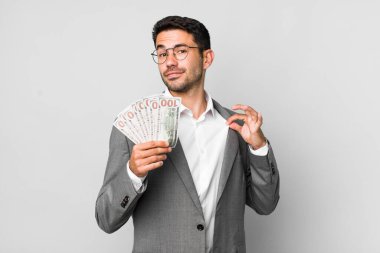 young adult handsome hispanic man business and banknotes concept