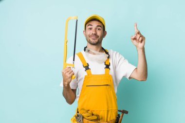 young adult man. handyman with a saw concept