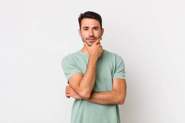 Young Handsome Hicpanic Man Looking Serious Thoughtful Distrustful One Arm — Stockfoto