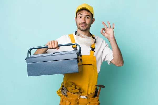 young adult man. plumber and toolbox concept