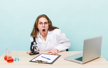 young physician woman with a microscophe. sciencist concept
